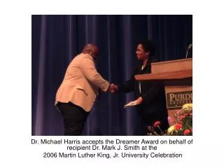 Dr. Michael Harris accepts the Dreamer Award on behalf of recipient Dr. Mark J. Smith at the